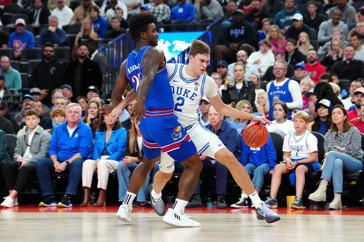 Duke Blue Devils guard Cooper Flagg (2) dribbles against Kansas Jayhawks forward KJ Adams (24) during the first half at T-Mobile Arena in Las Vegas on Nov. 26, 2024.