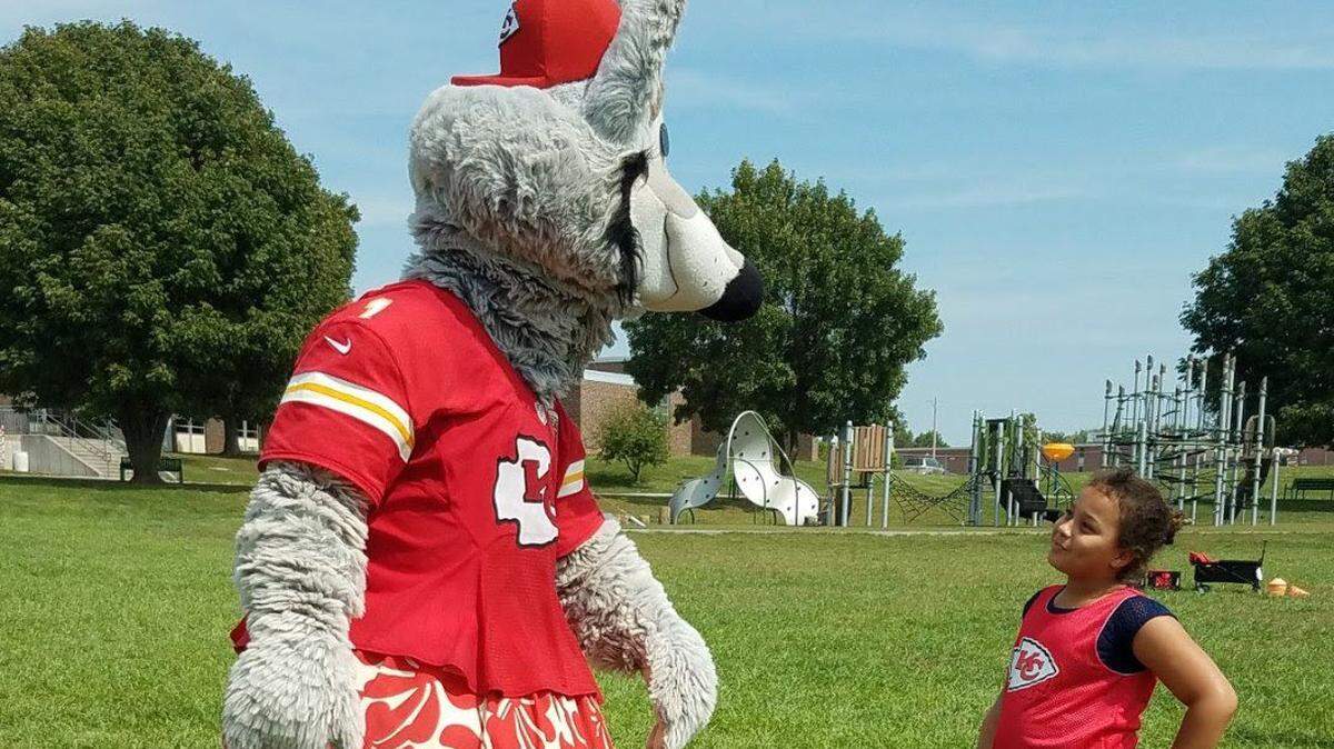 Pleasant Lea Elementary student Grace Jackson isn’t the least bit intimidated by Chiefs mascot K.C. Wolf.