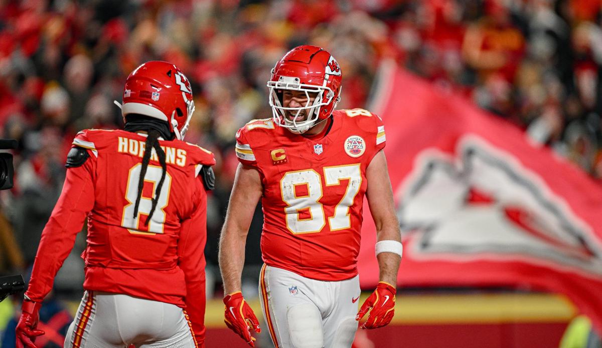 Kansas City Chiefs tight end Travis Kelce (87) smiled at wide receiver DeAndre Hopkins (8) after Kelce caught a pass for a touchdown in the fourth quarter against the Houston Texans during the AFC Divisional Round playoff game on Saturday, Jan. 18, 2025, at GEHA Field at Arrowhead Stadium.