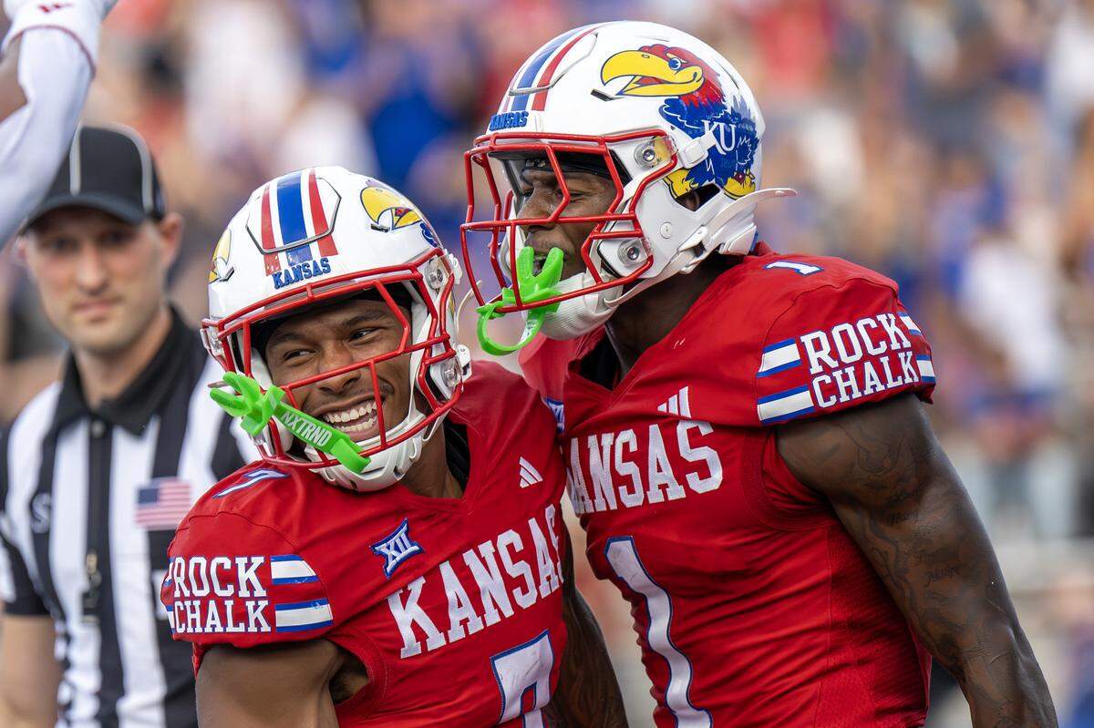 Kansas wide receiver Cam Pickett (7), left, and receiver Emmanuel Henderson Jr. (1) celebrate after Pickett scores a touchdown during the second quarter at David Booth Kansas Memorial Stadium on Friday, Aug. 29, 2025, in Lawrence.