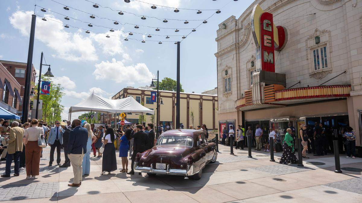 People gather around the re-opening of the pedestrian mall in the 18th & Vine Jazz District on Wednesday, May 27, in Kansas City.