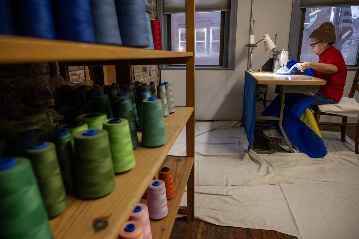 Using a single-thread machine, seamstress Phuong-Thu Nguyen, 78, adds a zigzag stitch to attach two stars to a flag of Curacao at All Nations Flag Co., on Thursday, Jan. 8, 2026, in Kansas City. The flag company will be stocking flags for all of the nations involved in this year's World Cup. Some flags will be made in-house, while others will be brought in from a U.S. manufacturer.