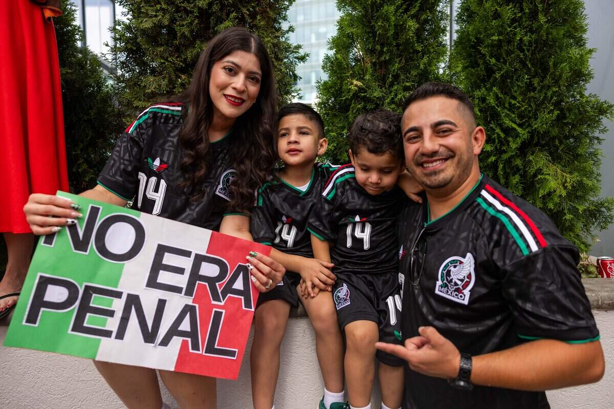 Danna, left, Edgar, Iker, and Guillermo Martinez pose with their “No Era Penal” sign at Power and Light on Thursday, June 25, 2026. Netherlands supporters march along Grand Boulevard alongside the Oranjebus, or "De beroemde Oranjebus”, before the Netherlands' match against Tunisia.Thousands of fans from across the United States and abroad dressed in orange packed the streets, cheering, singing, chanting, and celebrating as they followed the bus to FIFA Fan Fest.