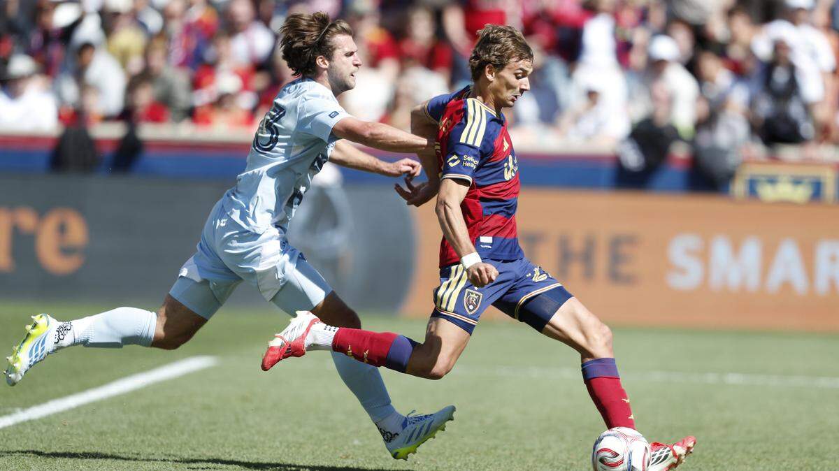 Real Salt Lake’s Sergi Solans, right, shoots past Sporting KC’s Ethan Bartlow during a Major League Soccer match at America First Field in Sandy, Utah on Saturday, April 4, 2026.