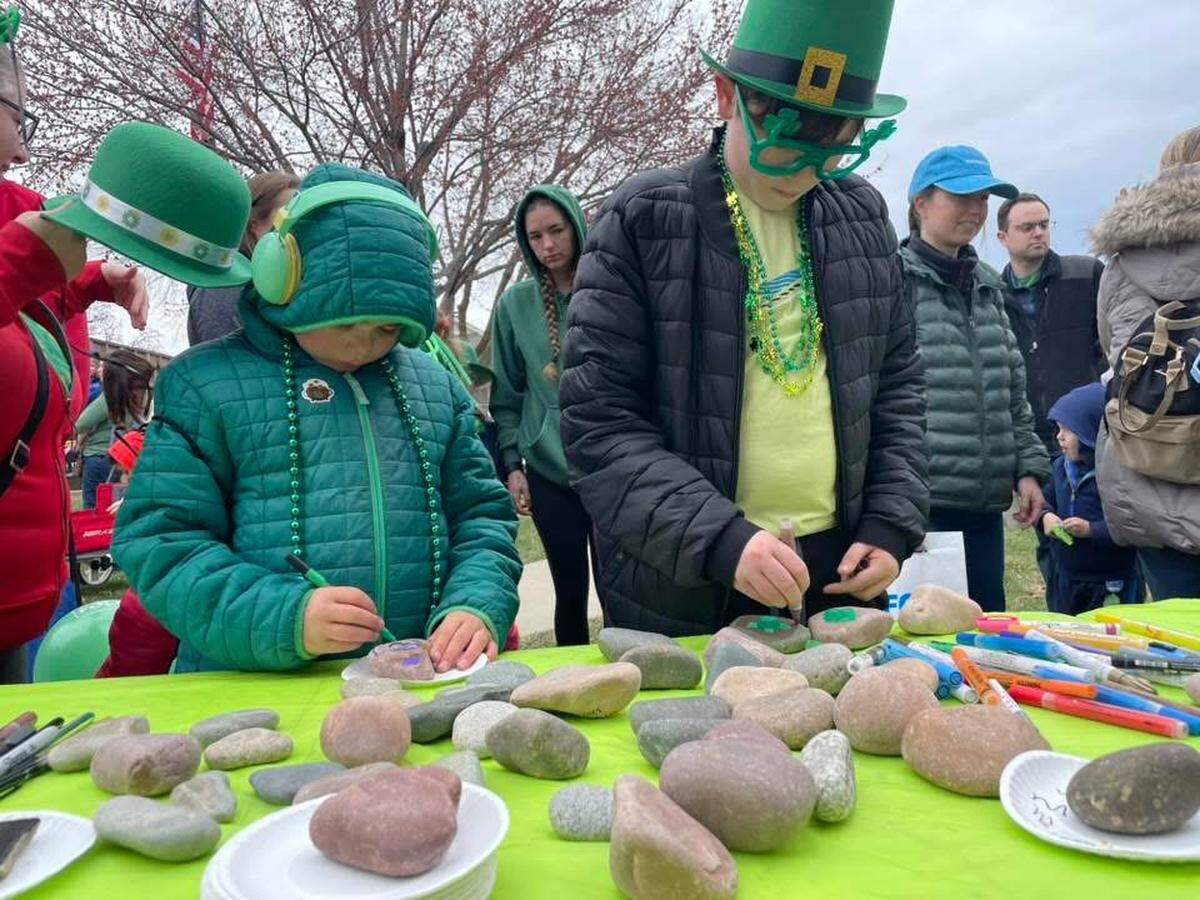 Kids paint kindness rocks at Alyssa’s Wishes St. Patrick's Day stand in Lee’s Summit.