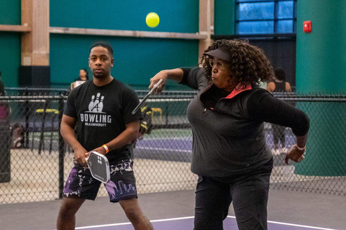 Mary Franklin returns a shot during a meeting of the Black Pickleball Club at SW19 at the Stadium, on Sunday, Feb. 22, in Kansas City. Franklin, who has played tennis for a while, recently began playing more pickleball lately and attends the club meetups regularly.