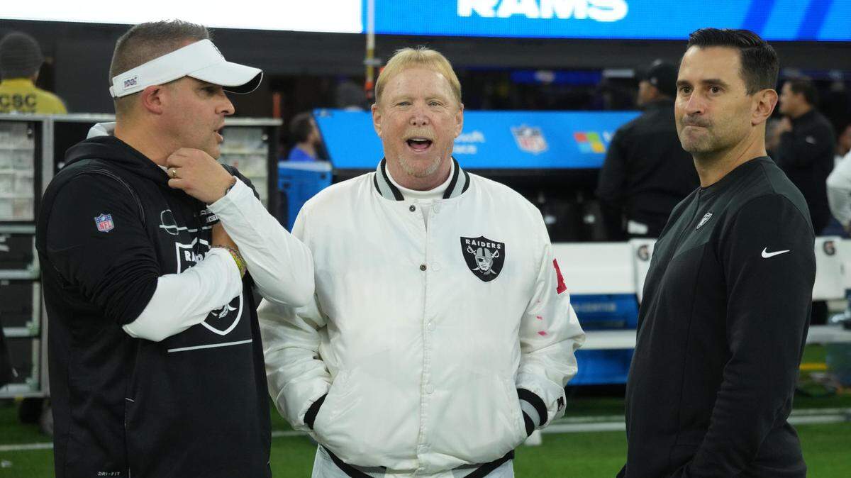Las Vegas Raiders coach Josh McDaniels (left), owner Mark Davis (center) and general manager Dave Ziegler talk before the game against the Los Angeles Rams at SoFi Stadium. 