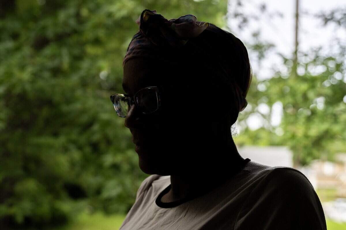 Shawanna Simms, who was wounded in a shooting along Interstate 70, is seen in silhouette at her home on Thursday, June 18, 2026, in Kansas City.