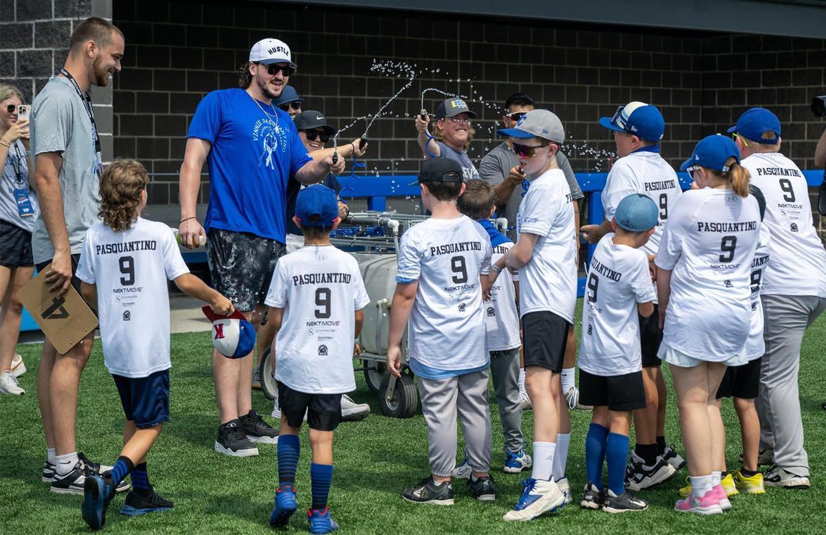 Kansas City Royals first baseman Vinnie Pasquantino squirts water on young players during a break at the Vinnie Pasquantino Baseball ProCamp at Grandview High School on Thursday, July 10, 2025, in Grandview, Missouri.