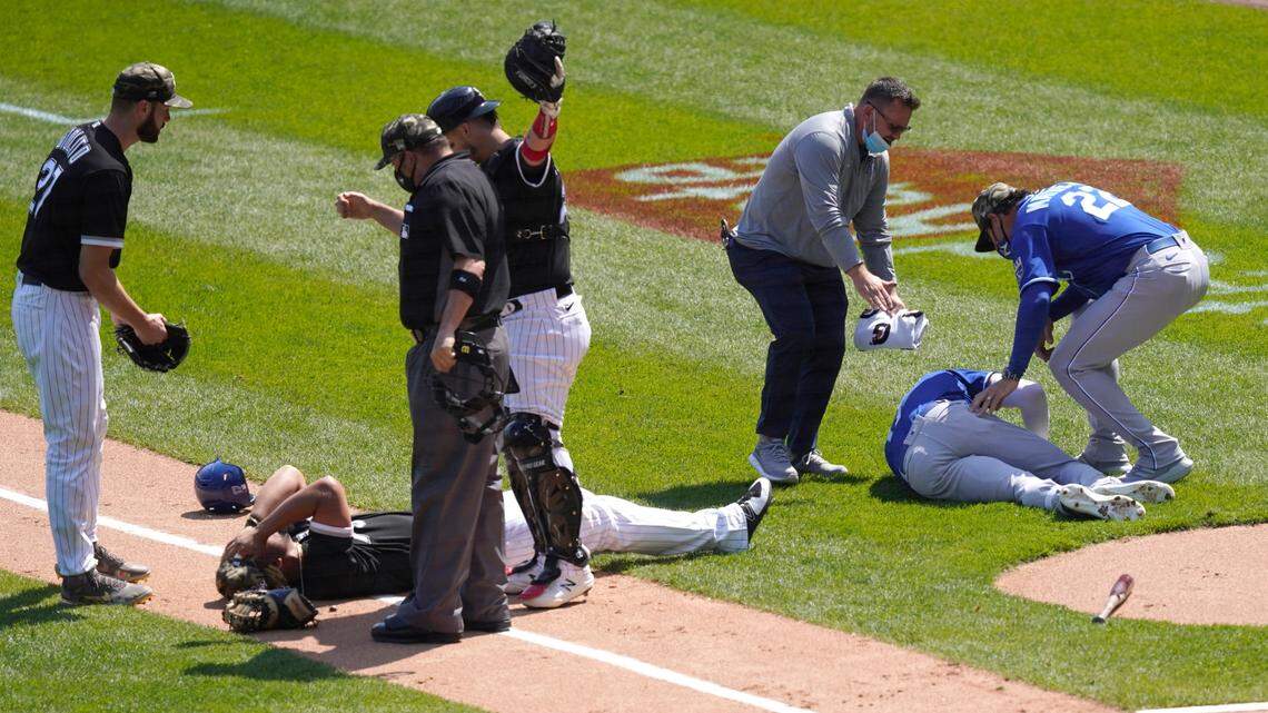 Chicago White Sox’s Jose Abreu, left, and Kansas City Royals’ Hunter Dozier lay near each other after colliding along the first base line in the second inning of the first game of a baseball doubleheader Friday, May 14, 2021, in Chicago. (AP Photo/Charles Rex Arbogast)
