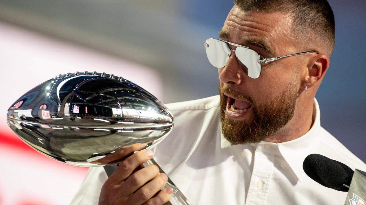 Kansas City Chiefs tight end Travis Kelce shouts while holding the Vince Lombardi Super Bowl Trophy during the NFL Draft outside of Union Station on Thursday, April 27, 2023, in Kansas City.