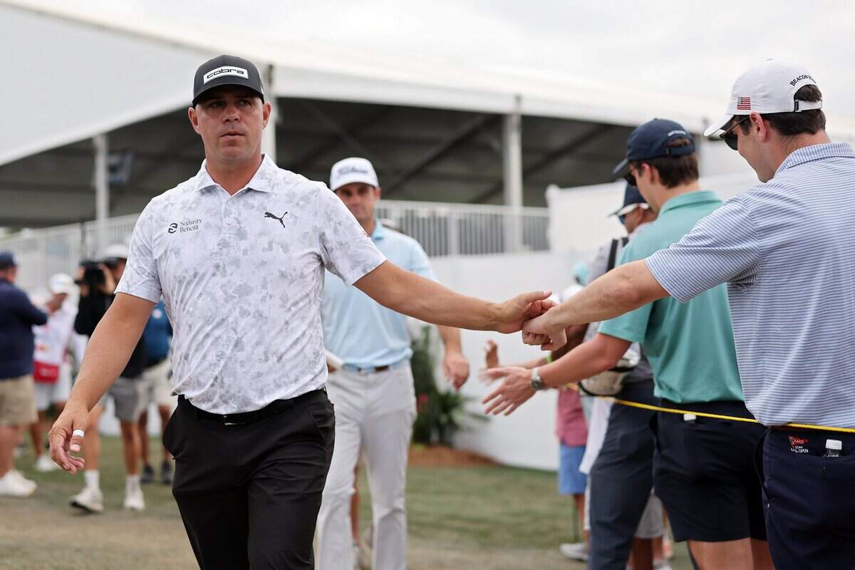 Former KU Jayhawks golfer Gary Woodland greets fans while walking to the 17th tee during Round 3 of the Texas Children’s Houston Open at Memorial Park Golf Course in Houston on March 28, 2026.