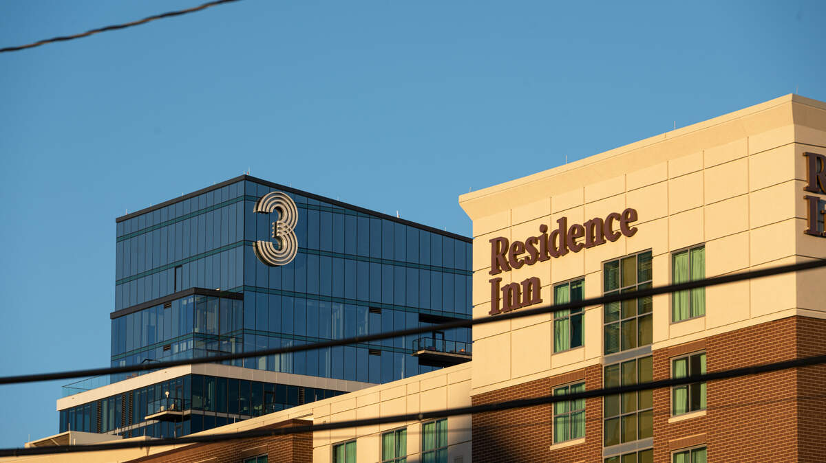 Evening sunlight cascades over the Three Light luxury apartment building on Wednesday, Oct. 18, 2023, in Kansas City. The large “3” on the building is a permanent fixture that is nearly 20 feet tall and 12 feet wide.