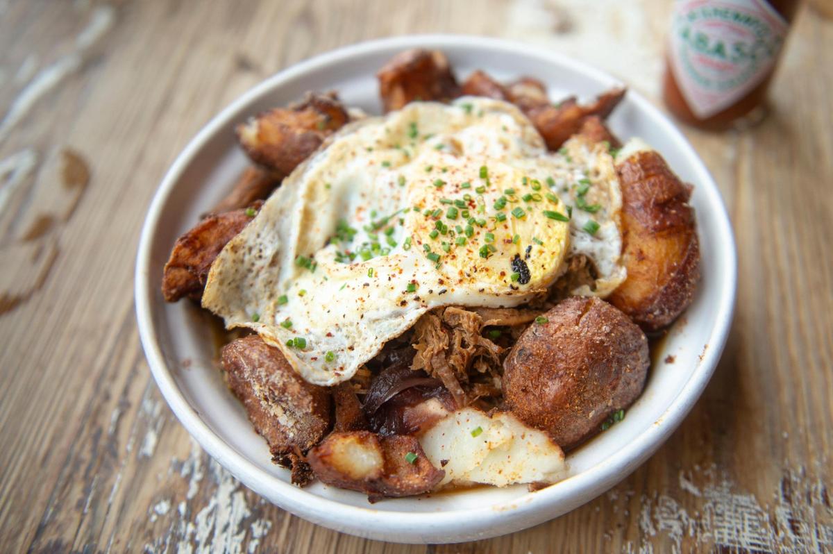 The hangover bowl, which consists of pork, grits, braised onion, garlic, potatoes and eggs, is served at Willa Jean in New Orleans.