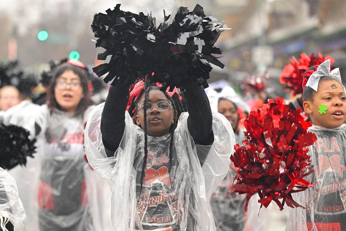 Extreme Team members from the Foreign Language Academy danced in the rain during the 2023 Brookside St. Patrick’s Day Warm-Up Parade on Saturday March 11, 2023 in Kansas City.