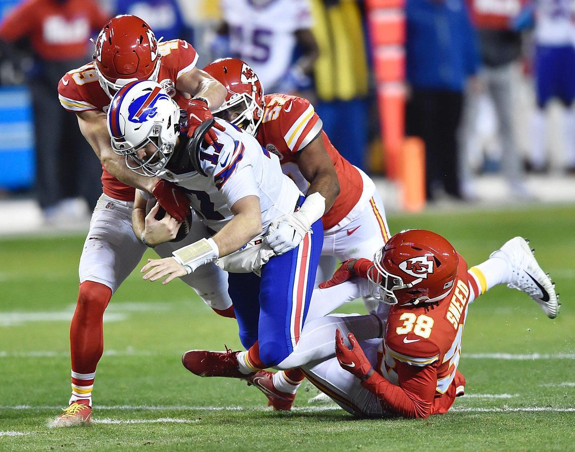 Kansas City Chiefs defenders Daniel Sorensen, Alex Okafor and L’Jarius Sneed sack Buffalo Bills quarterback Josh Allen in the first quarter Sunday, January 24, 2021, during the AFC Championship Game at Arrowhead Stadium in Kansas City, Missouri.