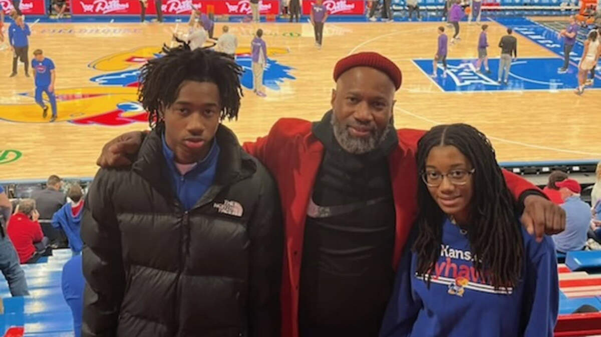 Toriano Porter and his children Giulian and Emilee Williams at the Sunflower Showdown at Allen Fieldhouse March 7