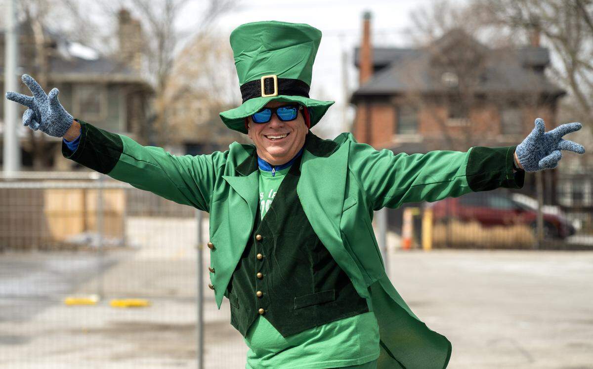 A participant dressed as a leprechaun smiles and poses for photos during the St. Patrick's Day parade along Broadway Boulevard on Tuesday, March 17, 2026, in Kansas City.