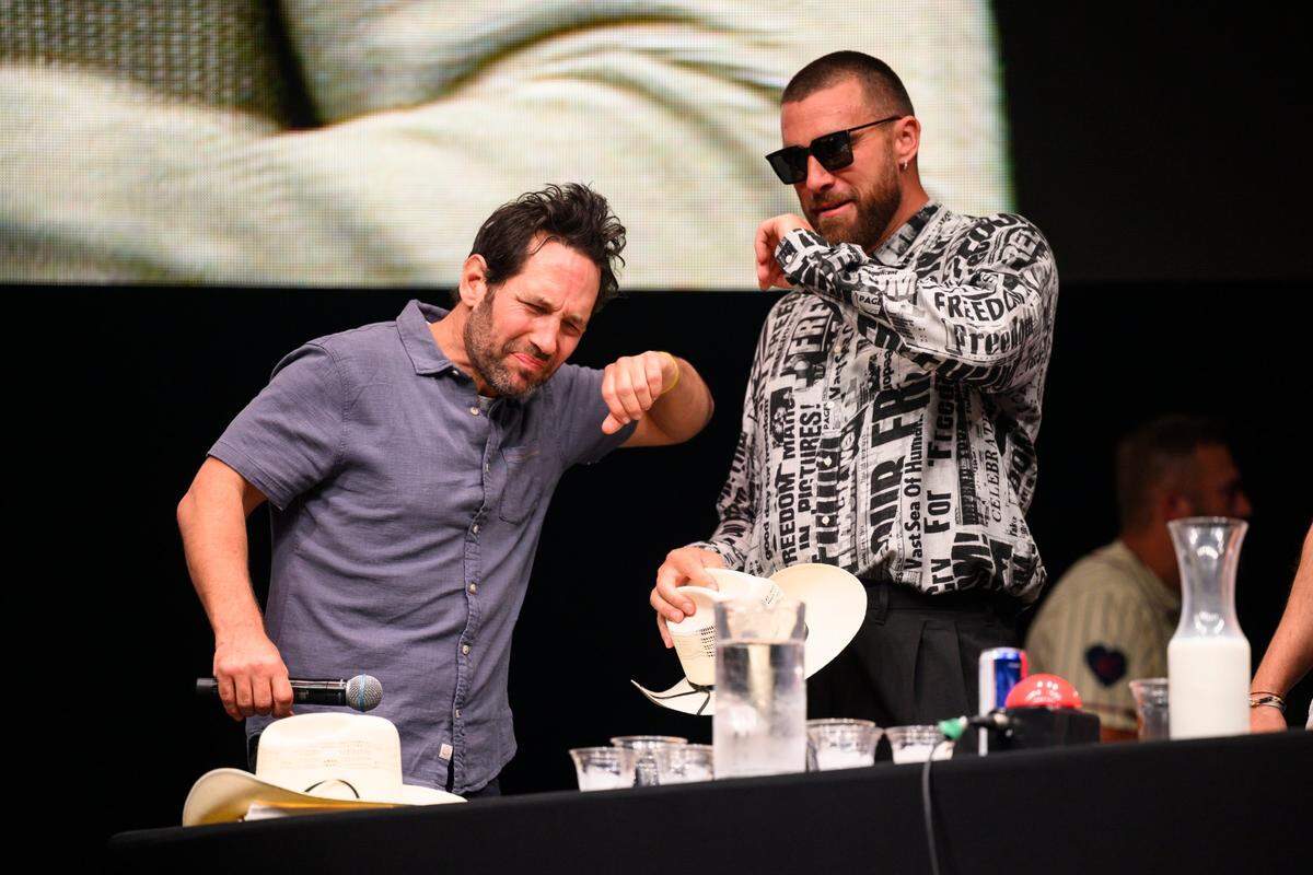 Former People Magazine Sexiest Man Alive, Paul Rudd, left, and current Sexiest Athlete, Travis Kelce react after having to eat a hot chicken wing during a contest at the Big Slick auction, Saturday, June 3, 2023.