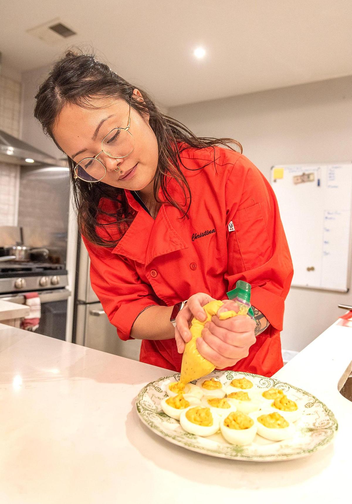 Christina Clark prepares deviled eggs as an appetizer at a private party.
