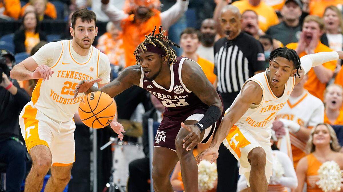 Texas A&M guard Tyrece Radford (23) loses the ball while driving against Tennessee guard Santiago Vescovi (25) and guard Kennedy Chandler (1) during the first half of an NCAA men’s college basketball Southeastern Conference tournament championship game Sunday, March 13, 2022, in Tampa, Fla. (AP Photo/Chris O’Meara)