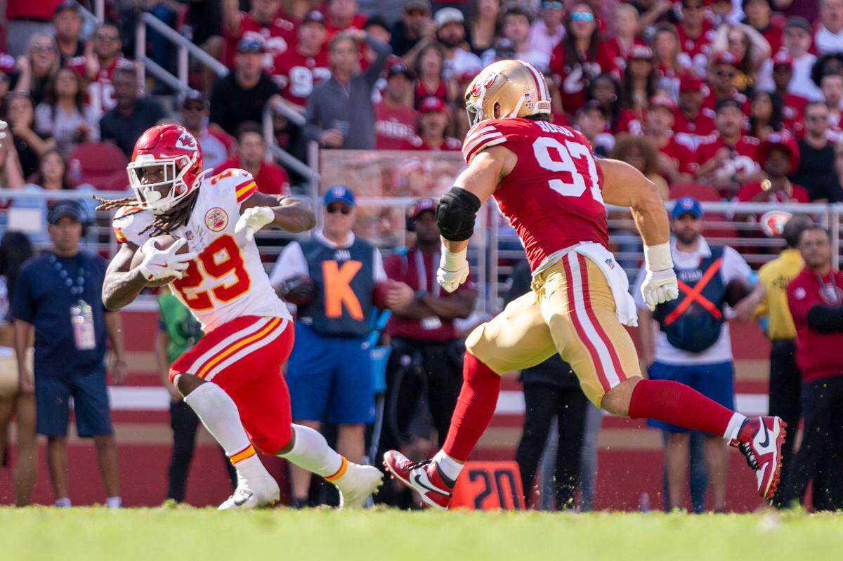 Kansas City Chiefs running back Kareem Hunt (29) runs the football against San Francisco 49ers defensive end Nick Bosa (97) during the second quarter at Levi’s Stadium.