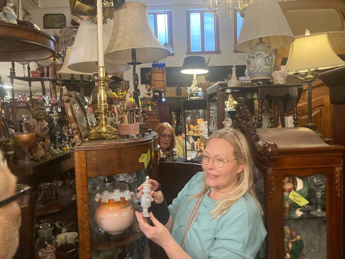 Stacy King of Lee’s Summit shops for French antiques at 4501 Genessee St. on Wednesday, March 11, on the first of the two days that the building was open to the public.