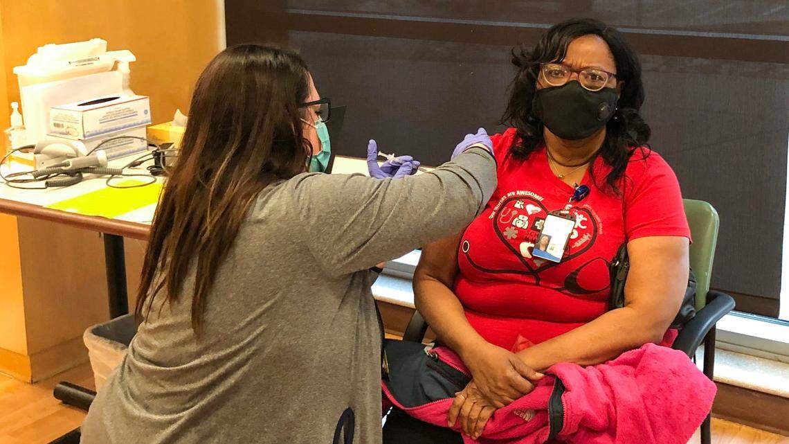 Paula Amaonye, a Kansas City Public Schools nurse, received a COVID-19 vaccine shot in January. Missouri teachers are still waiting and are told it could be April before their turn comes.