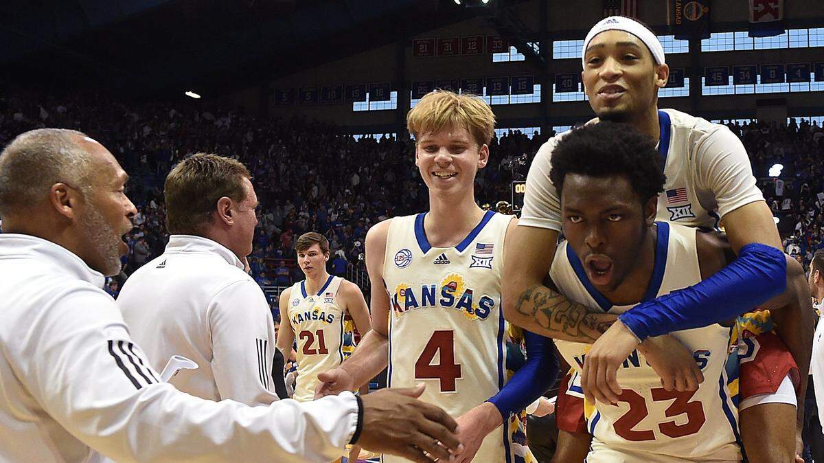 KU’s Dajuan Harris got a free ride to the locker room from teammate Ernest Udeh after the Jayhawks beat Baylor at Allen Fieldhouse.