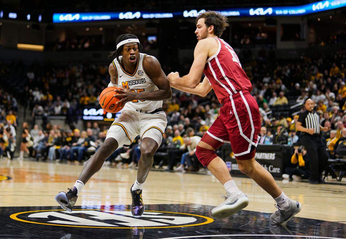 Missouri Tigers guard Mark Mitchell, left, drives against Oklahoma Sooners forward Sam Godwin during an SEC men’s basketball game Mizzou Arena in Columbia on Wednesday, Feb. 12, 2025.