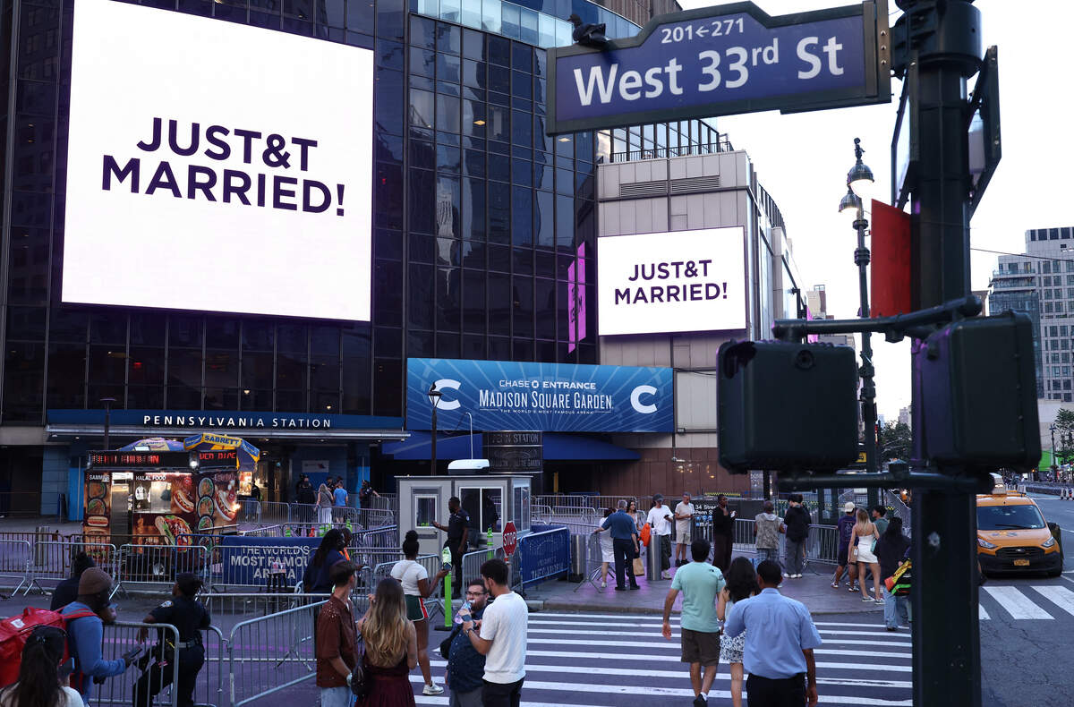 A giant screen shows the message "JUST&T MARRIED!" (T&T for Taylor and Travis) outside Madison Square Garden, the reported venue for the wedding celebrations of pop singer Taylor Swift and pro-athlete Travis Kelce, in New York City on July 3, 2026.