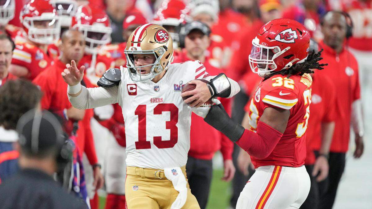 San Francisco 49ers quarterback Brock Purdy (13) and Kansas City Chiefs linebacker Nick Bolton (32) react while out of bounds during the second quarter of Super Bowl LVIII at Allegiant Stadium.