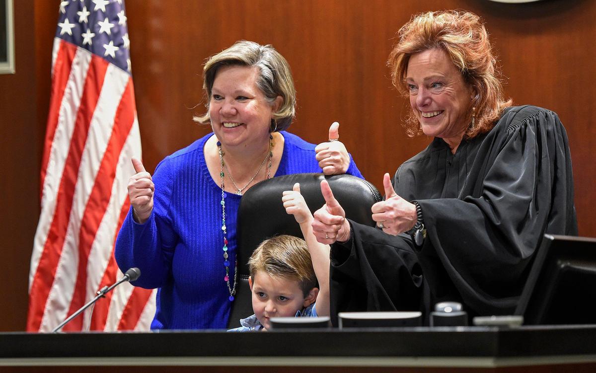 It was thumbs-up as Laura Jones, left, of Olathe, legally adopted Tyler Jaxson Jones, 6, during a court hearing before Judge Kathleen Sloan on Monday in Johnson County District Court in Olathe.