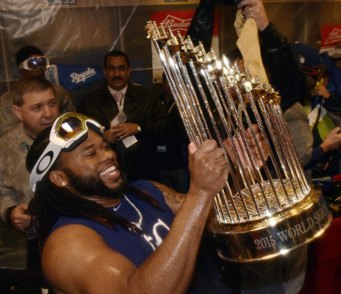 Kansas City Royals starting pitcher Johnny Cueto held the World Series trophy while the Royals celebrated in the clubhouse after winning the World Series on Sunday, November 1, 2015 at Citi Field in New York.