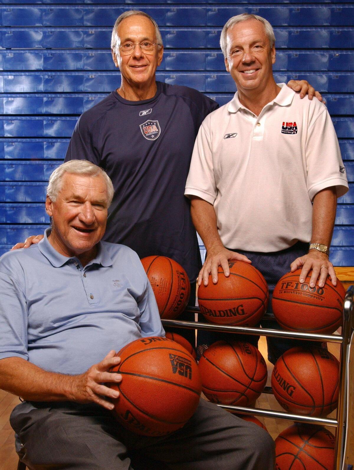 In 2004 USA Basketball Olympic Men’s Head Coach Larry Brown posed for a portrait with his assistant Roy Williams after practice at the University of North Florida Arena in Jacksonville, FL Wednesday afternoon. They were joined by their mentor, Hall of Fame UNC coach (seated) Dean Smith, also a former USA Olympic Basketball Coach.