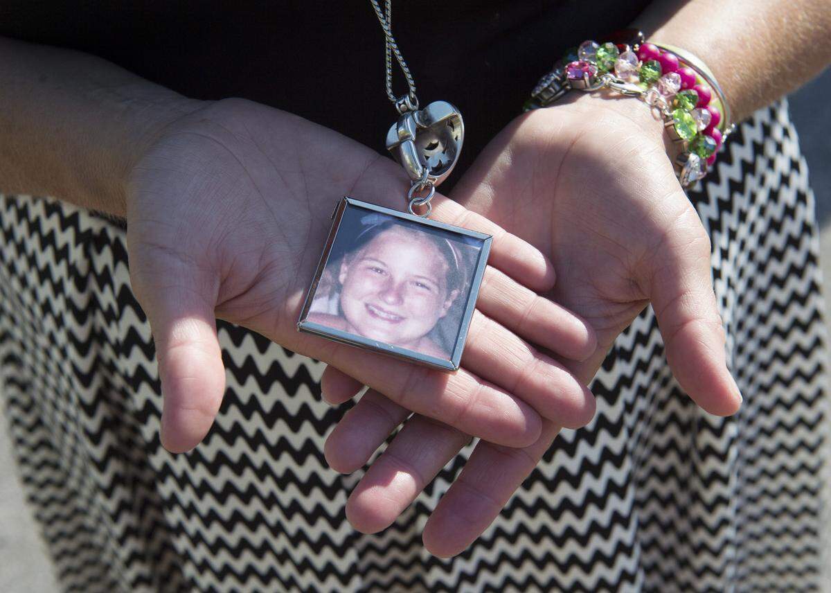 In this file photo, the image of Blair Michaela Shanahan Lane, an 11-year-old who was killed by a stray bullet on July 5, 2011, was on a necklace that Michele Shanahan DeMoss mother of Blair wore as she went door-to-door with Kansas City Police to help educate the public of the dangers of celebratory gunfire.