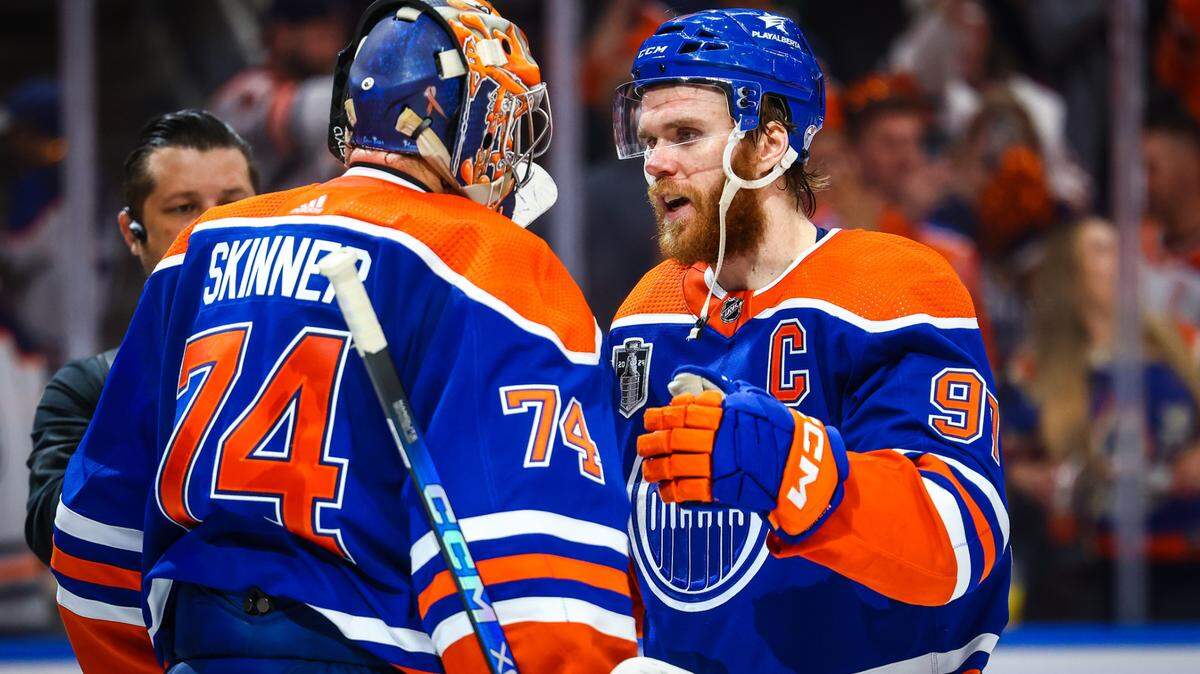 Edmonton Oilers goaltender Stuart Skinner (74) and center Connor McDavid (97) celebrates win after defeating Florida Panthers in Game 6 of the 2024 Stanley Cup Final at Rogers Place.