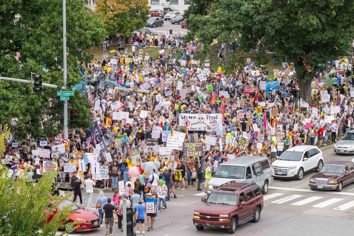 Demonstrators rally on Saturday, October 18, 2025, at Mill Creek Park in Kansas City as part of nationwide “No Kings” protests against the Trump administration. Protesters dressed up in costumes and brought signs showing their displeasure.