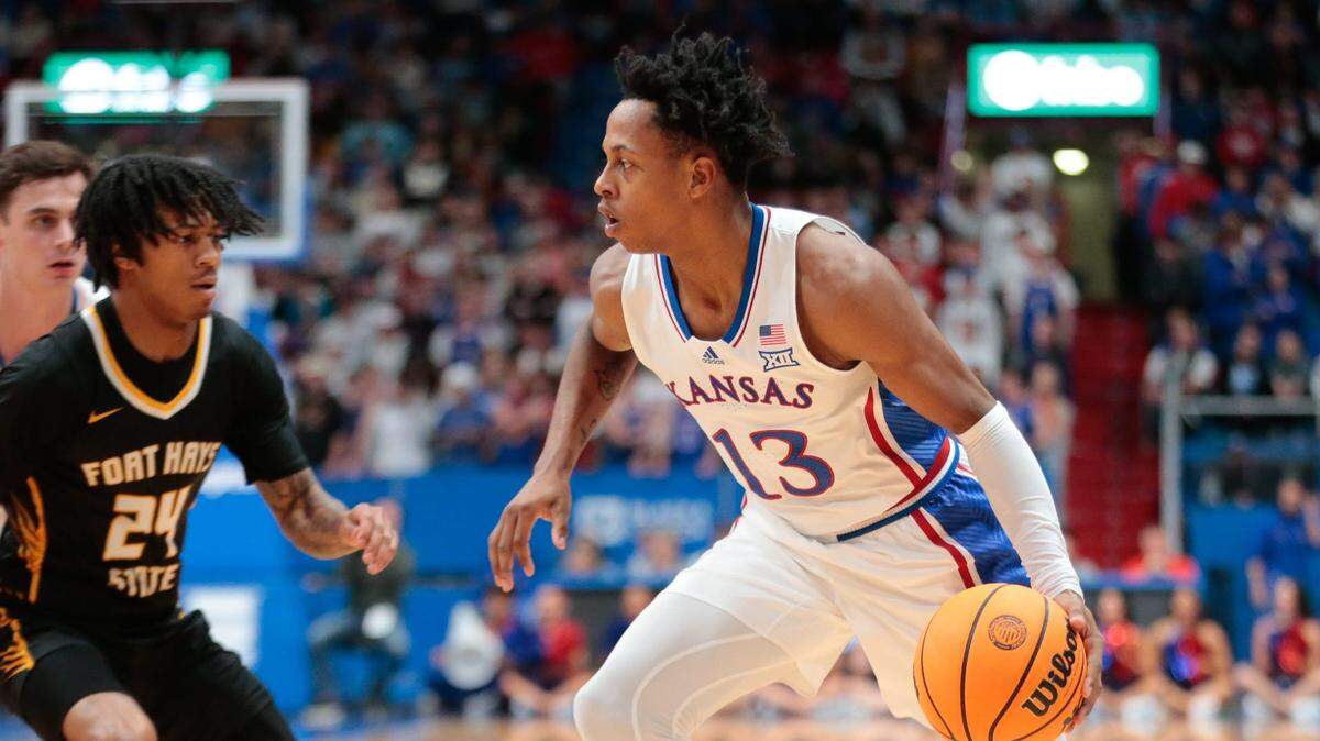 Kansas freshman Elmarko Jackson (13) drives the ball against Fort Hays State during the second half of an exhibition game inside Allen Fieldhouse on Nov. 1, 2023.