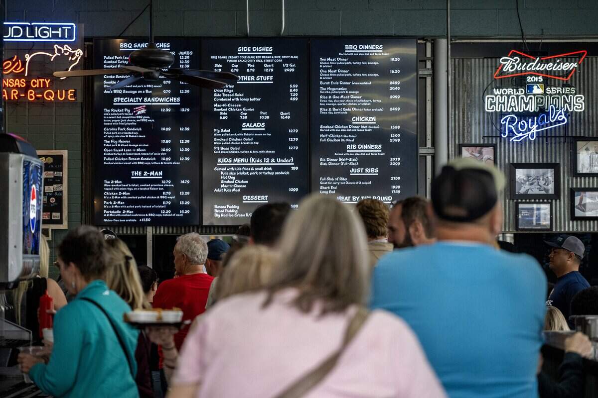 The menu is visible as customers stand in line at Joe's KC BBQ on Thursday, April 30, 2026, in Kansas City.