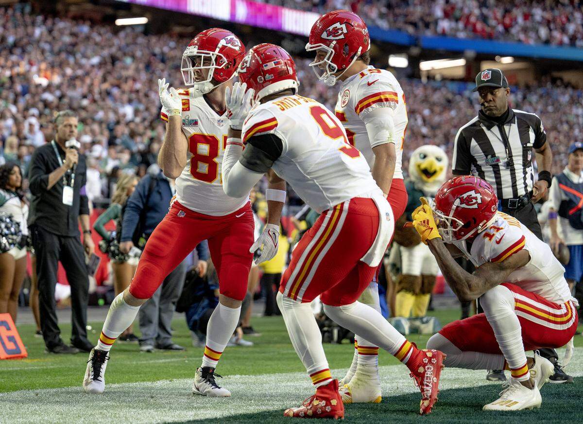 Kansas City Chiefs tight end Travis Kelce celebrates a touchdown with wide receiver JuJu Smith-Schuster, quarterback Patrick Mahomes and wide receiver Marquez Valdes-Scantling with his "stanky leg” dance during the Super Bowl LVII football game against the Philadelphia Eagles on February 12, 2023, in Glendale, Ariz.