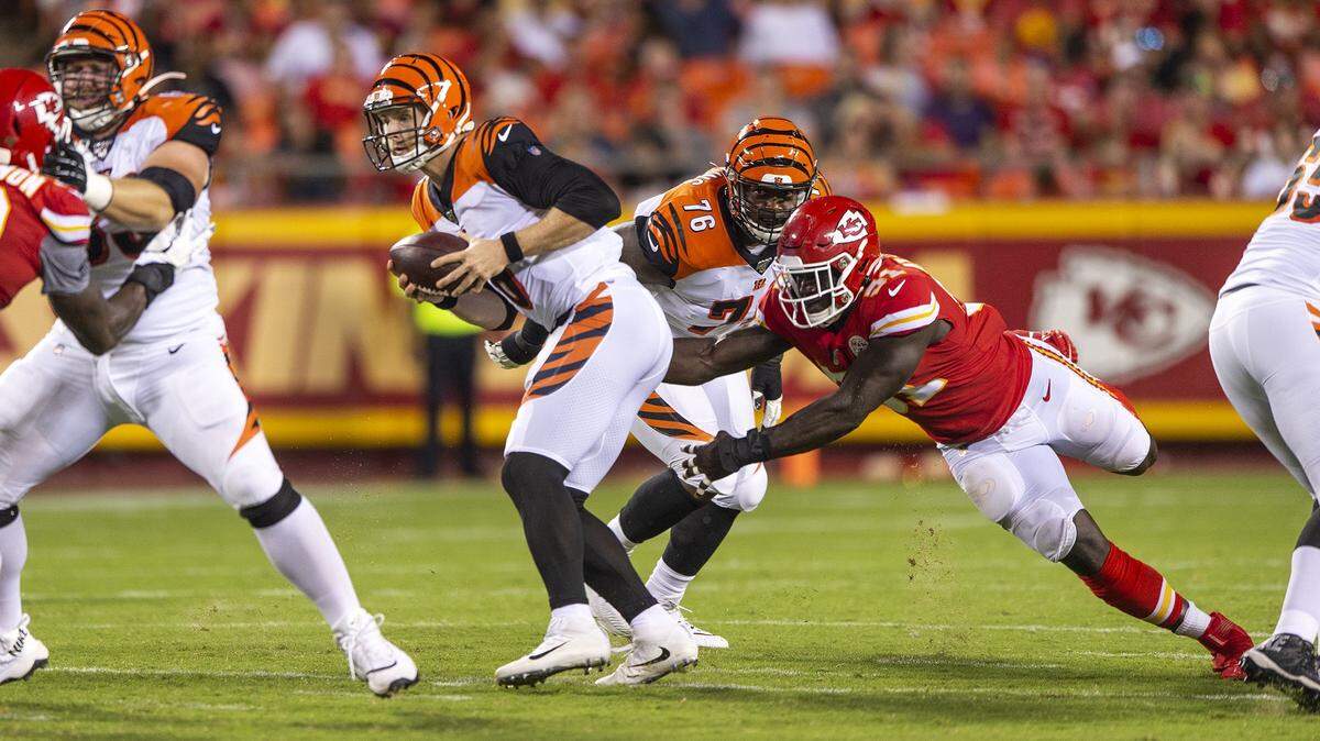 Kansas City Chiefs linebacker Jeremiah Attaochu tries to take down Cincinnati Bengals quarterback Jeff Driskel during a preseason game Saturday, Aug. 10, 2019, at Arrowhead Stadium.