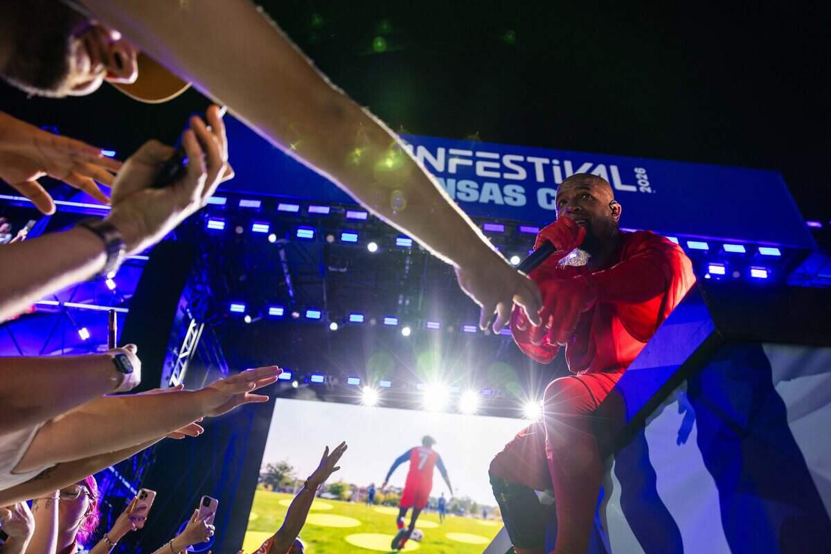 Tech N9ne reaches out to hold an attendees hand on stage during their FIFA Fan Fest concert at Fan Fest  on Friday, June 12, 2026.