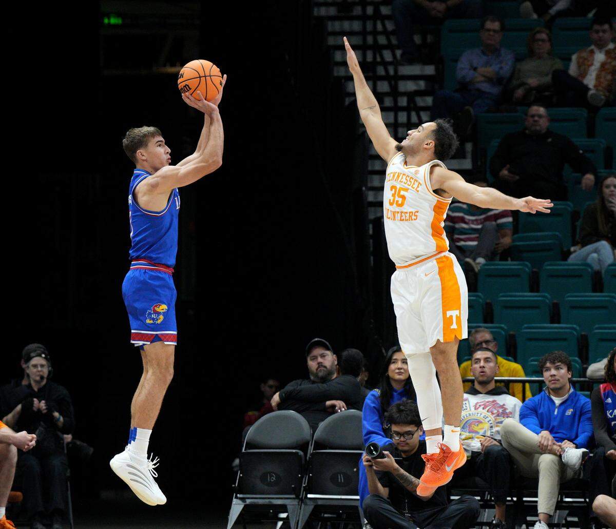 Kansas Jayhawks guard Kohl Rosario, left, puts up a 3-pointer against Tennessee Volunteers guard Ethan Burg during a Players Era men’s basketball tournament game at the MGM Grand Garden Arena in Las Vegas on Wednesday, Nov. 26, 2025.