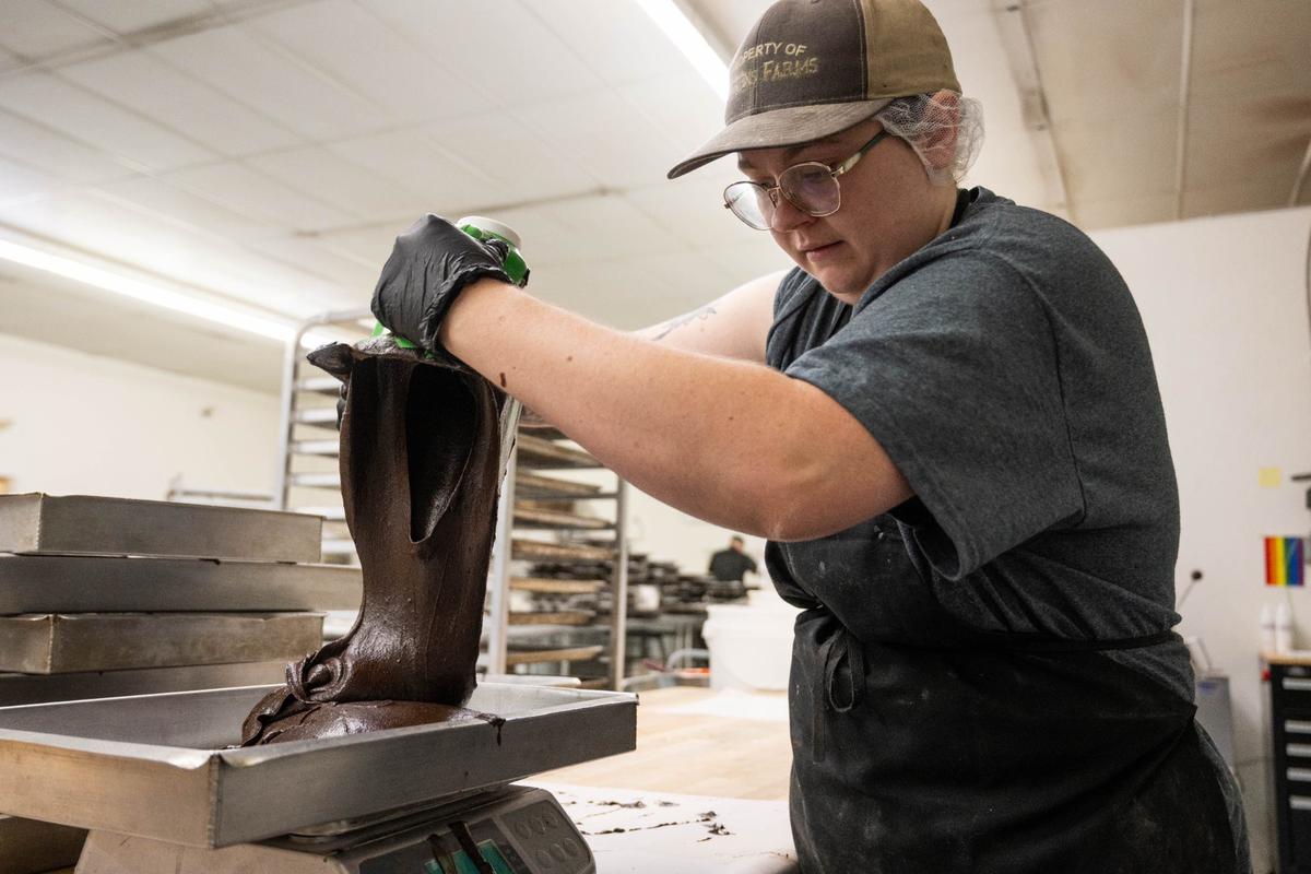 Production baker Jolynn Stevens pours brownie batter into a baking tray at Scratch KC in North Kansas City.