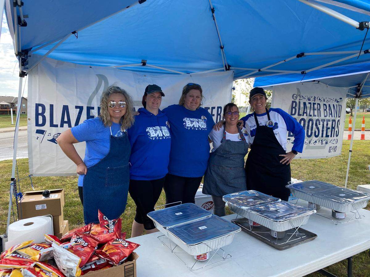 From left, Sheila Sloss, Nichole Griffith, Stephanie Bryan, Kari Tomlinson and Amy Higgins work a homecoming football game fundraiser for the Blazer Band Booster club.