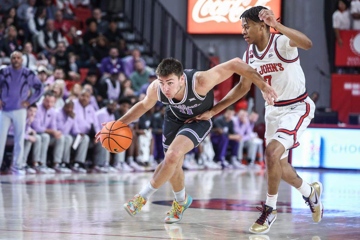 Kansas State Wildcats guard Brendan Hausen drives past St. John’s Red Storm guard Simeon Wilcher during a Saturday, Dec 7, 2024 college basketball game at Carnesecca Arena in Queens, New York.