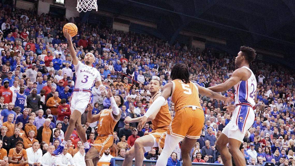 Kansas Jayhawks guard Dajuan Harris Jr. (3) shoots a layup as Texas Longhorns forward Timmy Allen (0) defends on Feb. 6, 2023, at Allen Fieldhouse.