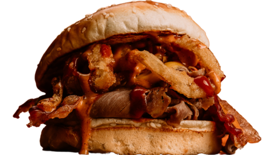 Beef-A-Roo’s Wild West roast beef sandwich is served on a sesame seed bun with bacon, American cheese, barbecue sauce and chipotle sauce, then topped with onion rings.