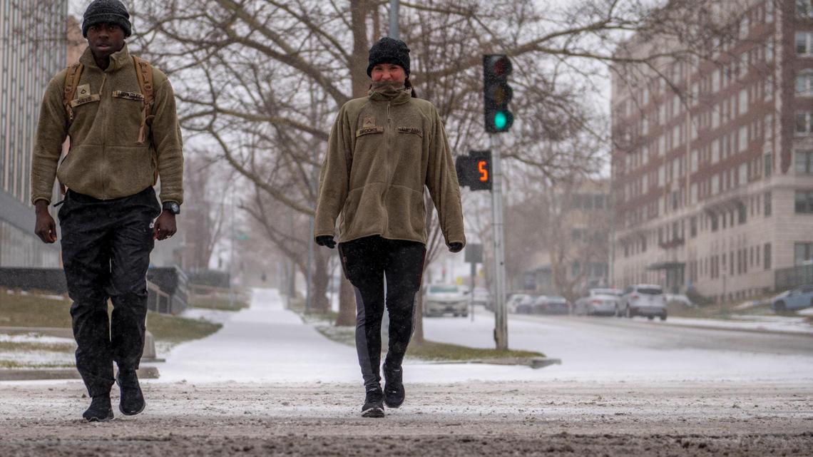 Omar Hayes (left) and his wife Donna Brooks walk together during a Saturday’s snowstorm in Kansas City. Hayes said that he and his wife decided to train in the snow, since he is being assigned to Fort Drum, N.Y. for the U.S. Army.
